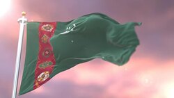 Flag of Turkmenistan waving at wind in slow at sunset, loop Stock Footage
