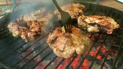 Tasty juicy meat is fried on a grill on a barbecue. Stock Footage