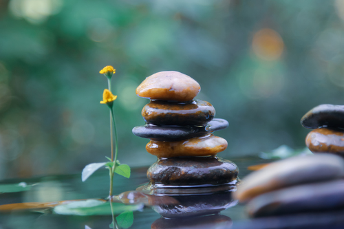 Preview of Emotional Balanced rocks pyramid on water with Golden light natural peace concep